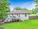 Home's backyard featuring a deck, stairs leading to the lawn, and partial fencing at 394 Thornbrooke Dr, Hiram, GA 30141