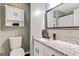 Bathroom featuring a granite countertop, vanity, a toilet, and a decorative mirror at 394 Thornbrooke Dr, Hiram, GA 30141