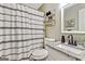 Stylish bathroom featuring a vanity with a granite countertop, a mirror, and a shower with decorative curtain at 394 Thornbrooke Dr, Hiram, GA 30141