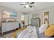 Bedroom featuring a bed, dressers, a ceiling fan, and wall decor at 394 Thornbrooke Dr, Hiram, GA 30141