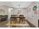 Inviting dining space with a classic table setting, decorative wall accents, and a seamless transition to the living room at 394 Thornbrooke Dr, Hiram, GA 30141