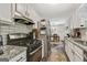 Modern kitchen featuring stainless steel appliances, granite countertops, and a seamless flow to the dining area at 394 Thornbrooke Dr, Hiram, GA 30141