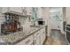 Well-lit kitchen featuring granite countertops, subway tile backsplash, and sleek fixtures, blending style and function at 394 Thornbrooke Dr, Hiram, GA 30141