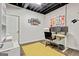 Home office space with three monitors, yellow rug, and art at 394 Thornbrooke Dr, Hiram, GA 30141