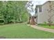 Grassy backyard featuring the back of the house with stairs leading to a deck at 4135 Coursey Lake Rd, Douglasville, GA 30135