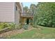 The back of the house and a deck overlook a garden and backyard with flowers at 4135 Coursey Lake Rd, Douglasville, GA 30135