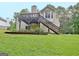 Backyard features grass and a view of the back of the house with a deck and stairs at 4135 Coursey Lake Rd, Douglasville, GA 30135