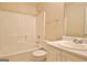 Bright bathroom features a tub/shower combo, vanity with sink, and neutral decor at 4135 Coursey Lake Rd, Douglasville, GA 30135