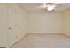 The bedroom boasts neutral carpet, multiple doors, and a ceiling fan at 4135 Coursey Lake Rd, Douglasville, GA 30135