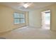 Spacious bedroom features a ceiling fan and an open doorway to the ensuite bathroom at 4135 Coursey Lake Rd, Douglasville, GA 30135