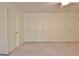 Bedroom with neutral carpet and multiple doors leading to closets at 4135 Coursey Lake Rd, Douglasville, GA 30135