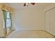 Carpeted bedroom with window that provides natural light and double-door closet at 4135 Coursey Lake Rd, Douglasville, GA 30135