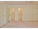 Bedroom with neutral carpet features 3 doors, 2 leading to spacious closets at 4135 Coursey Lake Rd, Douglasville, GA 30135
