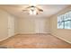 This bedroom is carpeted and features a ceiling fan, closet, and a window at 4135 Coursey Lake Rd, Douglasville, GA 30135