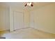 Bright bedroom featuring neutral carpet, a ceiling fan, and a double-door closet for ample storage at 4135 Coursey Lake Rd, Douglasville, GA 30135