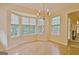 Bright dining room featuring a bay window, chandelier and hardwood floors; well-lit ambiance at 4135 Coursey Lake Rd, Douglasville, GA 30135