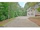 Long driveway leading to a two-car garage, surrounded by lush greenery at 4135 Coursey Lake Rd, Douglasville, GA 30135