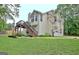 The back of this home features a deck, stairs, and an attached garage at 4135 Coursey Lake Rd, Douglasville, GA 30135