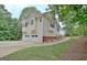 Home with a two-car garage, side yard, and driveway, surrounded by trees at 4135 Coursey Lake Rd, Douglasville, GA 30135