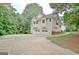 Two-story home with a two-car garage and ample parking space on a large driveway at 4135 Coursey Lake Rd, Douglasville, GA 30135