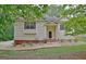 Charming home exterior with vinyl siding, mature trees, and well-maintained landscaping at 4135 Coursey Lake Rd, Douglasville, GA 30135