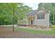 Attractive front of house with lawn, trees, and sidewalk leading to the front door at 4135 Coursey Lake Rd, Douglasville, GA 30135
