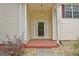 Close-up of front entrance featuring a glass door with house number and overhead light at 4135 Coursey Lake Rd, Douglasville, GA 30135
