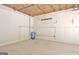 A clean garage featuring concrete block walls and a blue water pressure tank at 4135 Coursey Lake Rd, Douglasville, GA 30135