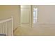 Hallway with carpeting leading to a room with tile flooring and double doors at 4135 Coursey Lake Rd, Douglasville, GA 30135