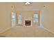 Bright living room featuring a fireplace, neutral carpet, and access to the backyard at 4135 Coursey Lake Rd, Douglasville, GA 30135