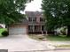Charming two-story brick home with a front-facing garage and landscaped yard at 2225 Blue Ridge Ln, Conyers, GA 30012