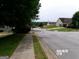 Residential street view showcasing a home with lawn and mature trees at 2225 Blue Ridge Ln, Conyers, GA 30012