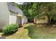 View of the backyard with a shed, wooden porch, and green grass at 537 Country Lake Dr, Mcdonough, GA 30252