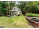 Backyard view with gazebo, nice brickwork and landscaping, lush green grass and siding shed at 537 Country Lake Dr, Mcdonough, GA 30252