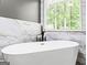 Elegant bathroom with a free standing tub and sleek fixtures at 537 Country Lake Dr, Mcdonough, GA 30252