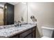 Bathroom features a dark vanity with white, granite countertop and updated faucets at 537 Country Lake Dr, Mcdonough, GA 30252