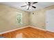A bedroom offering hardwood floors, neutral paint, ceiling fan, and a window at 537 Country Lake Dr, Mcdonough, GA 30252