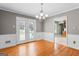 Dining room with hardwood floors and a chandelier with french doors leading to the outside at 537 Country Lake Dr, Mcdonough, GA 30252