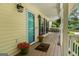 Inviting front porch, featuring potted flowers, a swing, and a well-maintained wood deck at 537 Country Lake Dr, Mcdonough, GA 30252