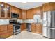 Updated kitchen with stainless steel appliances, granite countertops, and wooden cabinets at 537 Country Lake Dr, Mcdonough, GA 30252