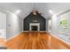 Spacious living room with hardwood floors, stone fireplace, a ceiling fan and ample natural light at 537 Country Lake Dr, Mcdonough, GA 30252