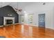 Spacious living room with hardwood floors, stone fireplace, a ceiling fan and ample natural light at 537 Country Lake Dr, Mcdonough, GA 30252