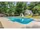 Large backyard pool with slide and diving board, surrounded by lush greenery and a charming gazebo at 537 Country Lake Dr, Mcdonough, GA 30252