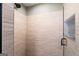 Updated shower with glass surround and neutral colored brick style wall tiles at 537 Country Lake Dr, Mcdonough, GA 30252