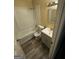 Cozy bathroom with a shower and tub combo, single sink vanity, and updated flooring at 1932 Pharrs Rd, Snellville, GA 30078