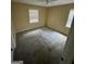 This bedroom has neutral walls and carpet, plus a ceiling fan and a window at 1932 Pharrs Rd, Snellville, GA 30078
