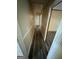Hallway featuring wood floors, neutral colored walls, and white trim throughout the home at 1932 Pharrs Rd, Snellville, GA 30078