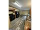 Eat-in kitchen with dark cabinetry, granite countertops, and sleek black appliances at 1932 Pharrs Rd, Snellville, GA 30078
