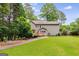 Exterior view of a well-maintained home with a spacious backyard, perfect for outdoor entertaining at 90 Thomas Overby Dr, Sharpsburg, GA 30277