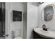 Bathroom featuring modern fixtures, a vanity sink, toilet and decorative mirror at 90 Thomas Overby Dr, Sharpsburg, GA 30277